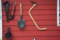 Tools and equipments farm gardening on red wooden wall of barn farmhouse for farmer use growing cultivating horticulture at meadow Royalty Free Stock Photo