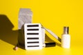 Tools for eyelash extension on stones on a yellow background. Artificial eyelashes, lashmaker tools