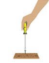 Hand of woman worker screws in a wooden block with a screwdriver Royalty Free Stock Photo