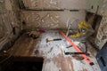 Tools on the floor of a room in a home or appartment which is being stripped for renovation