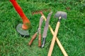 Tools for garden care. Manual electric lawn mower, shovel, rake, machete, scissors. Trim the green lawn.