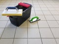 Tools for grouting ceramic tiles. Tilers using a rubber trowel and sponge