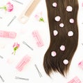 Tools for hair styling and petals on white background. Beauty composition. Flat lay, top view Royalty Free Stock Photo