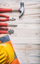 Tools, hardhat on wooden desk, top view Royalty Free Stock Photo