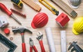 Tools, hardhats and project plans on wooden desk, top view Royalty Free Stock Photo