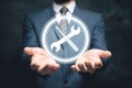 tools icon. wrench and screwdriver. the man holds in his hand. tech support concept