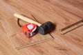 Rubber hammer with tape measure,tools for laying a parquet board on the floor Royalty Free Stock Photo