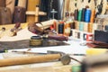 Tools and leather at cobbler workplace. Set of leather craft tools on wooden background Royalty Free Stock Photo