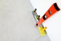 Tools for leveling walls on a white plastered wall. Preparing walls for wallpapering Royalty Free Stock Photo