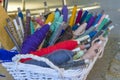 Tools for a loom in a basket: cotton yarn dyed in natural colors, shuttle, ball of thread. Close-up Royalty Free Stock Photo