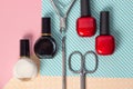 Tools for manicure on a pink and blue background. Nail files, scissors and nail polishes top view. Nail Salon