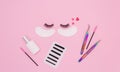 Tools and patches for eyelash extensions and artificial eyelashes on a pink background. Tools for the lashmaker. The view from the
