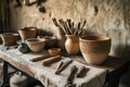 Tools for pottery arranged on a rustic table in a pottery studio surrounded by natural textures Royalty Free Stock Photo