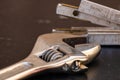 Tools for repair and building. Adjustable spanner, ruler and instruments on black wooden table with copy space Royalty Free Stock Photo