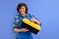 Tools for repair. Young builder man in workwear holds tool box isolated in studio Royalty Free Stock Photo