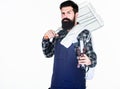 Tools for roasting meat outdoors. Picnic and barbecue. Cooking meat in park. Masculine hobby. Bearded hipster wear apron Royalty Free Stock Photo