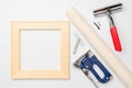 Tools for stretching a canvas with a photo on a wooden stretcher. Square stretcher, canvas roll, tongs, fasteners and a gun for