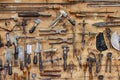 The tools of a tanner on the wall in a tannery. Royalty Free Stock Photo