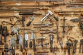 The tools of a tanner for working with leather on the wall in a tannery. Royalty Free Stock Photo