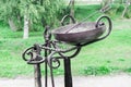 Tools for torture at medieval festival close-up. On metal stand hangs leather whip, tongs and bowl for testing with hot iron. Royalty Free Stock Photo