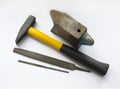 Tools on white background, hammer, anvil, needle files