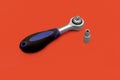 Tools for work, semi-automatic screwdriver with black plastic handle on red background. One bit construction tool Royalty Free Stock Photo