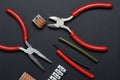 Tools for working with electricity, terminal blocks and heat shrink tubes lie on a dark background Royalty Free Stock Photo