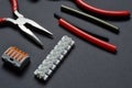 Tools for working with electricity, terminal blocks and heat shrink tubes lie on a dark background Royalty Free Stock Photo