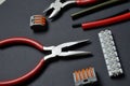Tools for working with electricity, terminal blocks and heat shrink tubes lie on a dark background Royalty Free Stock Photo