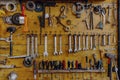 The tools of a workshop hanging on a wooden panel Royalty Free Stock Photo