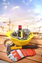 Tools in a yellow helmet on a construction site with a background crane Royalty Free Stock Photo