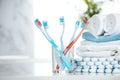 Tooth brushes and towels stack in bathroom.Tothbrush on glass on table empty copy sapce Royalty Free Stock Photo