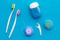 Tooth care with toothbrush, dental floss and dentist instruments. Set of cleaning products for teeth on blue background Royalty Free Stock Photo