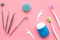Tooth care with toothbrush, dental floss and dentist instruments. Set of cleaning products for teeth on pink background Royalty Free Stock Photo