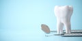Tooth and dental tools on blue background. Dental care, treatments and oral health background Royalty Free Stock Photo