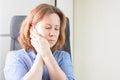Tooth disease, toothache, dental problems, a woman in the office with a toothache holds her cheek with her hand Royalty Free Stock Photo