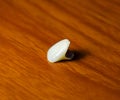 Tooth, metal ceramic crown on the table. Denture made of metal ceramics Royalty Free Stock Photo