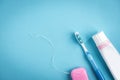 Tooth paste, brush and dental floss on blue background. cleaning and protection of teeth. Royalty Free Stock Photo