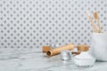 Tooth powder, brushes and jars on white marble table, space for text Royalty Free Stock Photo