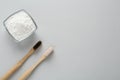 Tooth powder and brushes on white background, flat lay. Space for text Royalty Free Stock Photo