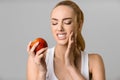 Tooth problems. Young woman having toothache, biting apple Royalty Free Stock Photo