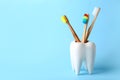 Tooth shaped holder with brushes on color background