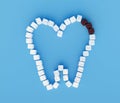 Tooth from sugar cubes on blue background, some brown sugar cubes, concept for sweet tooth, caries