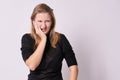 Toothache. Unpleasant sensations. Young girl. White background