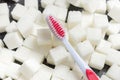 Toothbrush on the background of the sugar cubes of refined sugar, preventing tooth decay, caring for the health of your teeth Royalty Free Stock Photo