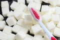 Toothbrush on the background of the sugar cubes of refined sugar, preventing tooth decay, caring for the health of your teeth Royalty Free Stock Photo