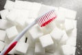 toothbrush on the background of the sugar cubes of refined sugar, preventing tooth decay, caring for the health of your teeth Royalty Free Stock Photo