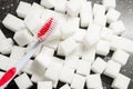 toothbrush on the background of the sugar cubes of refined sugar, preventing tooth decay, caring for the health of your teeth Royalty Free Stock Photo