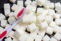 toothbrush on the background of the sugar cubes of refined sugar, preventing tooth decay, caring for the health of your teeth