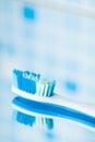 Toothbrush on blue tile background with mirror reflection Royalty Free Stock Photo